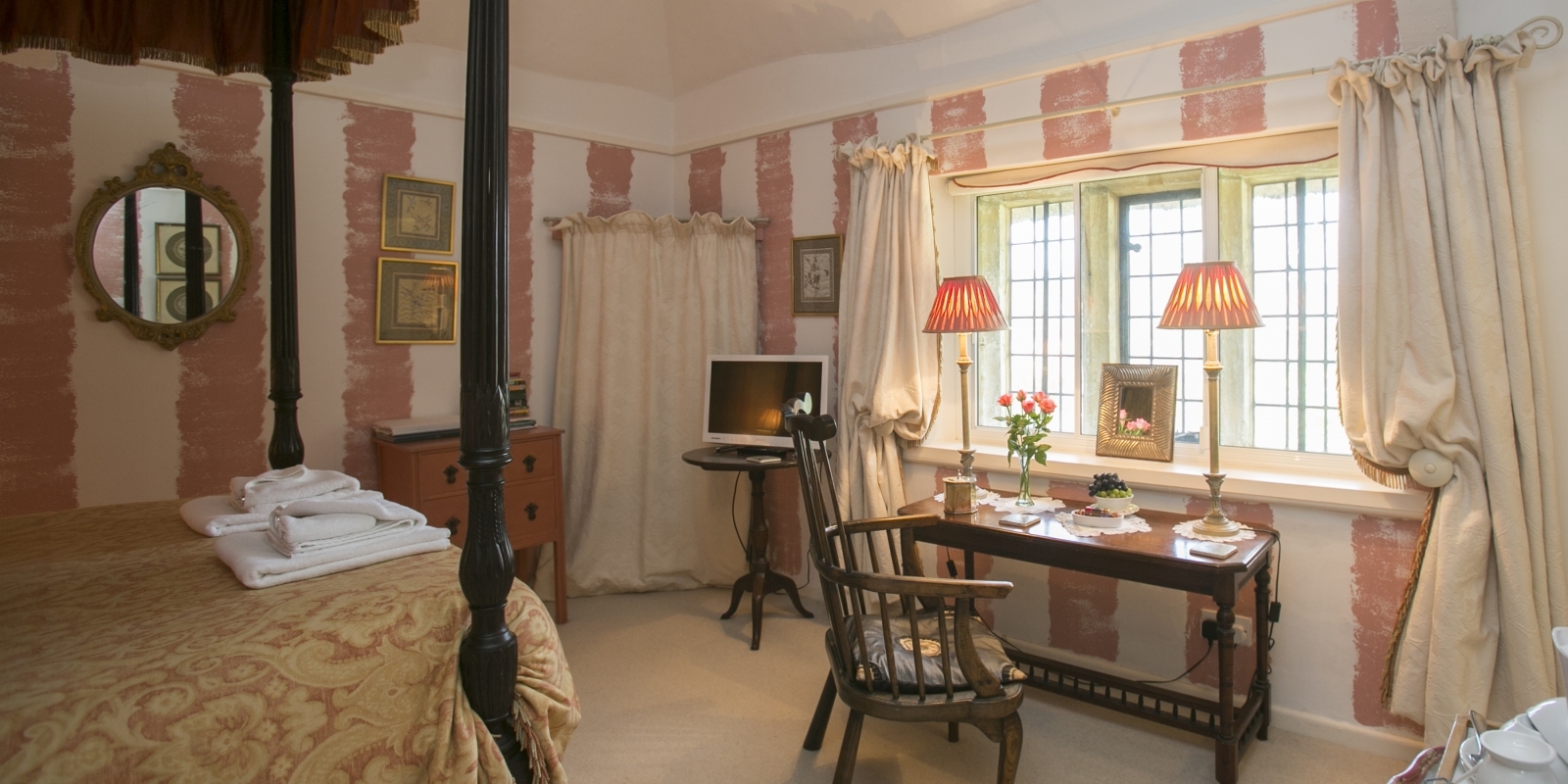 Four-poster bedroom at Tudor Cottage Guest House Dorchester